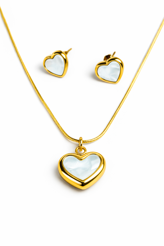 Gold heart-shaped necklace and earrings on a white background by Zenva