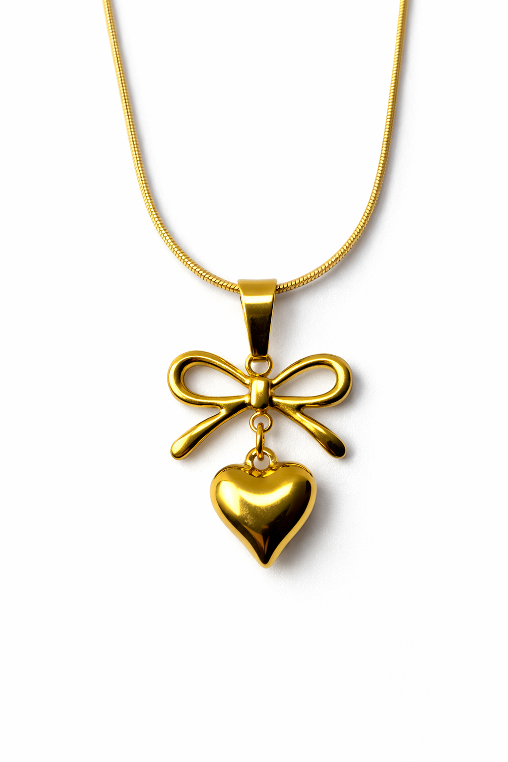 Gold necklace with a heart and bow pendant on a white background by Zenva