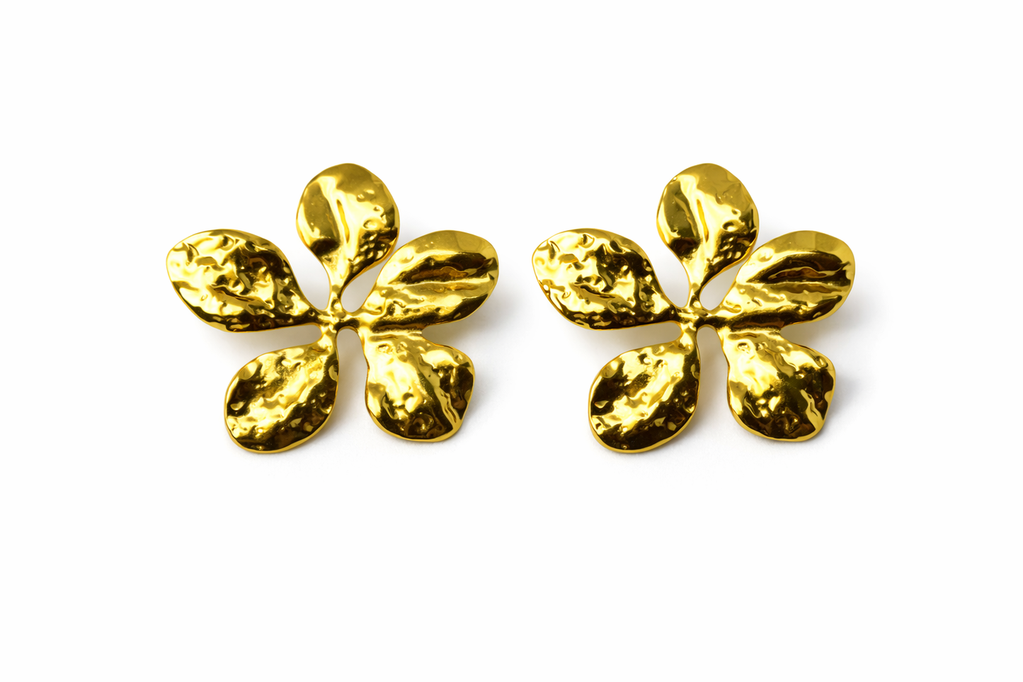 Pair of gold flower-shaped earrings on a white background by Zenva