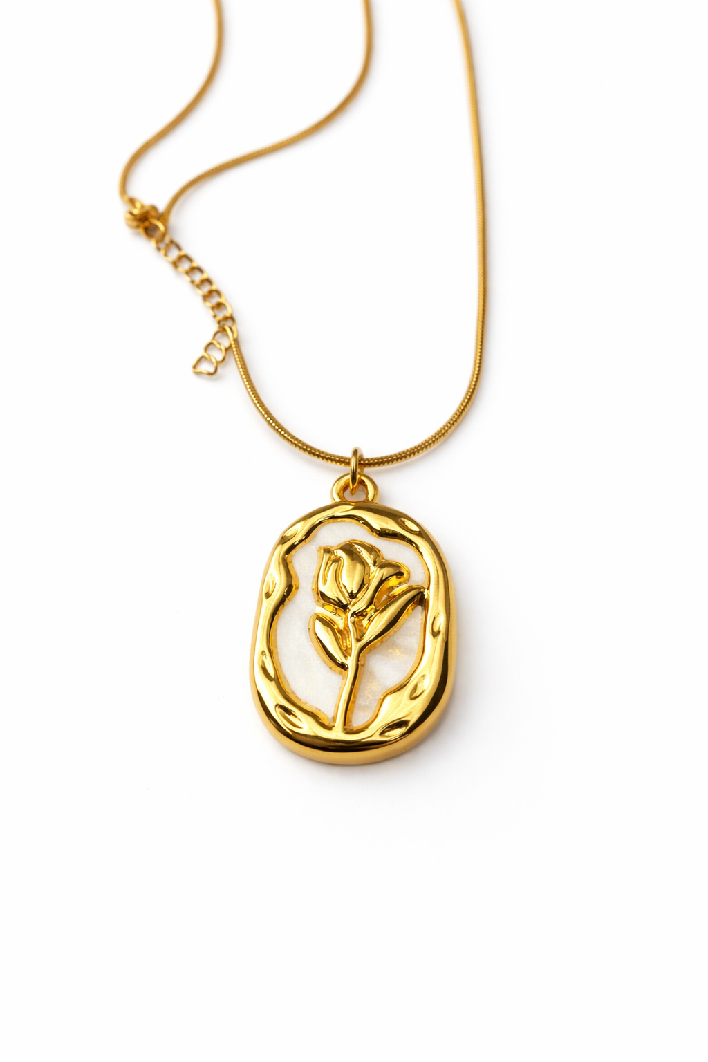 Gold necklace with a rose pendant on a white background by Zenva