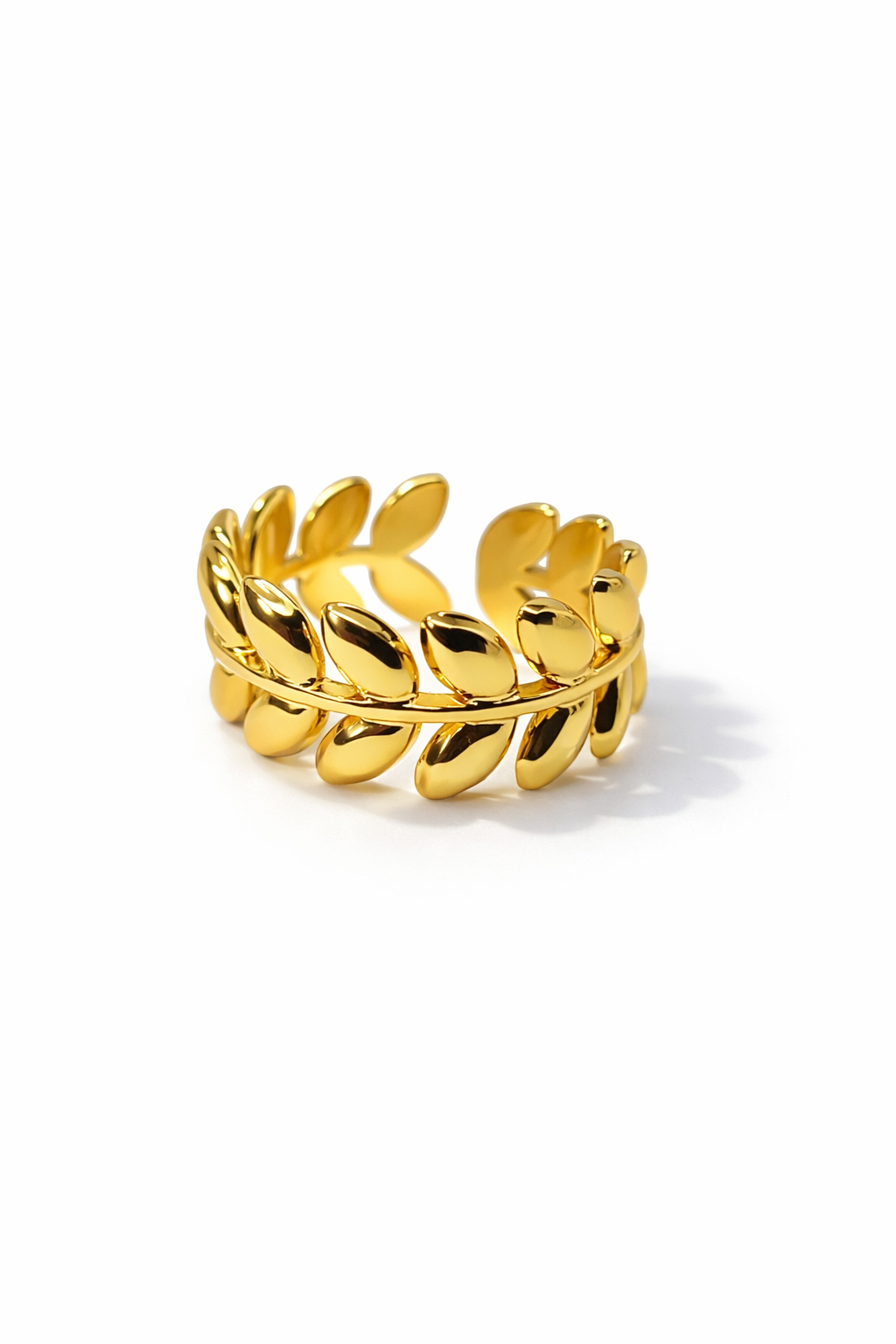 Gold leaf-shaped ring on a white background by Zenva