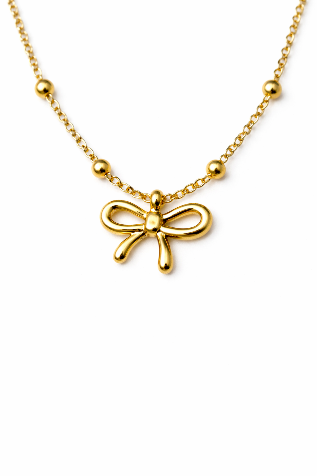 Gold bow-shaped pendant necklace on a white background by Zenva