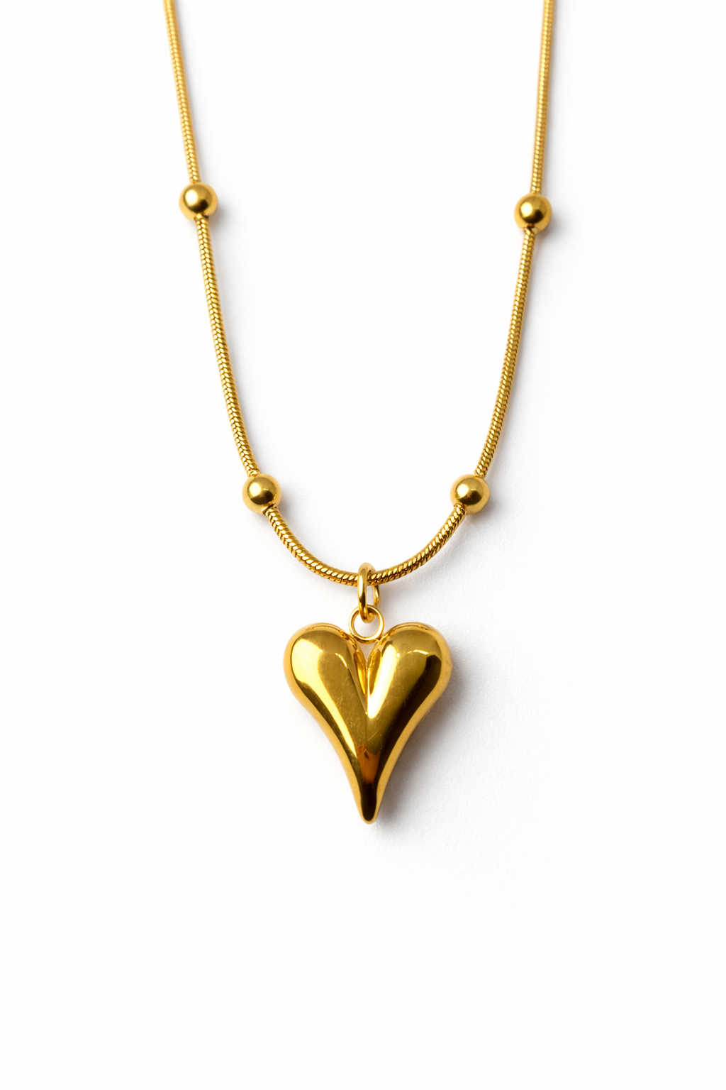 Gold heart-shaped pendant necklace on a white background by Zenva
